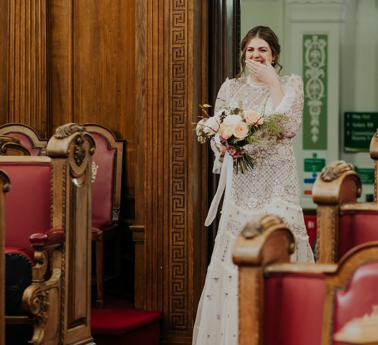 Bride walks through doors of Town Hall to her wedding ceremony