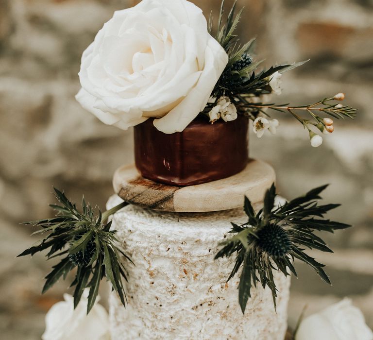 Cheese tower wedding cake with white flowers