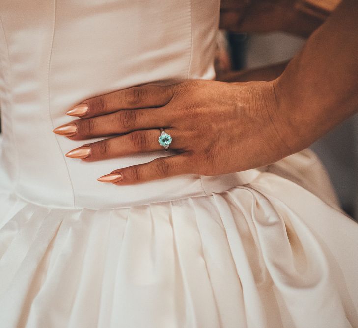 Bride wears gold nail varnish and light green coloured engagement ring | Nicola Thompson Photography