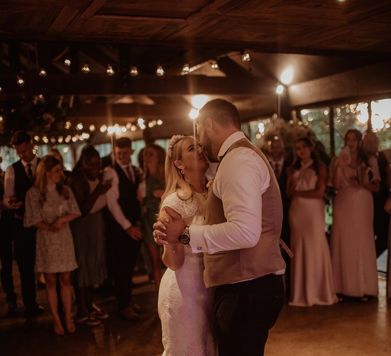 First dance at Dewsall Court with bride in a lace cap sleeve wedding dress and groom in a waistcoat