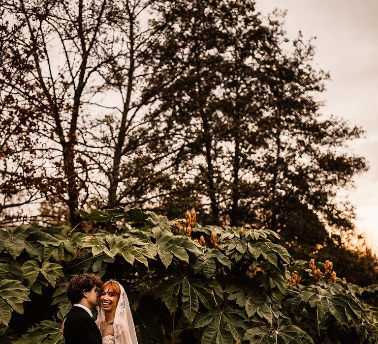 Bride and groom share a moment at Oxnead Hall wedding venue