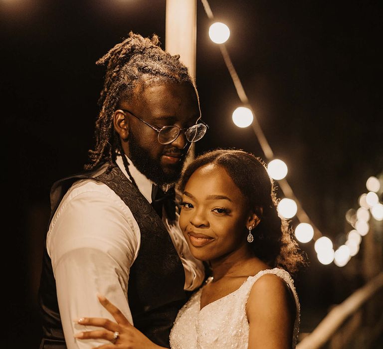 Bride leans in to her groom on wedding day