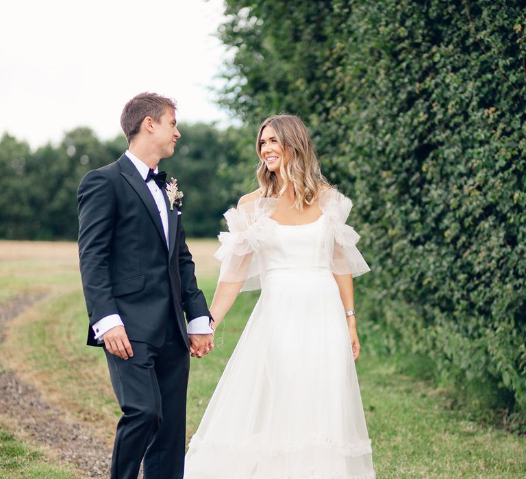 Bride in Halfpenny London wedding dress with groom in tuxedo for black tie wedding