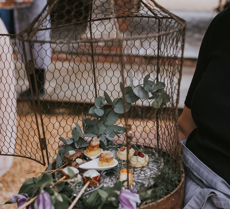 Cages with hors d'oeuvres for vegan, vegetarian and meat eater wedding guests