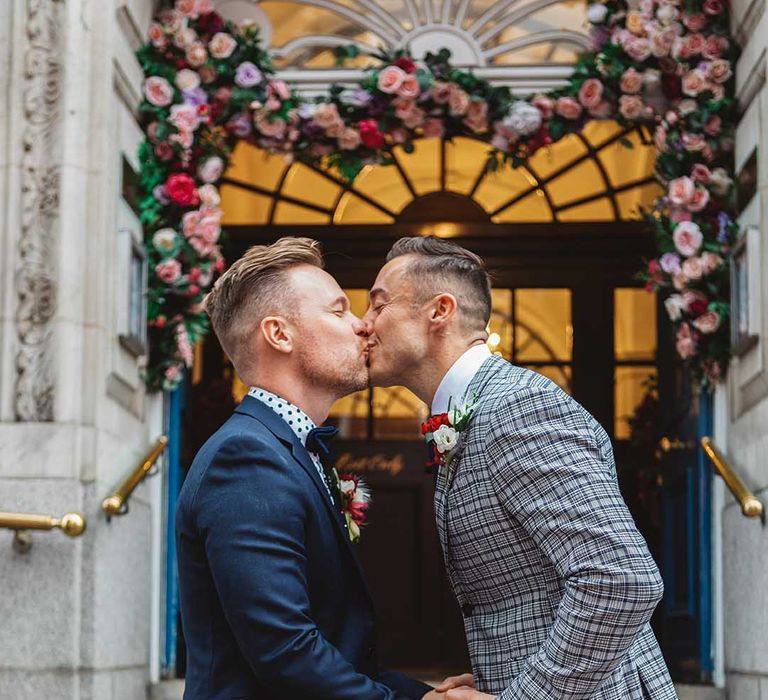 Grooms kiss on the steps of Chelsea Old Town Hall on their wedding day