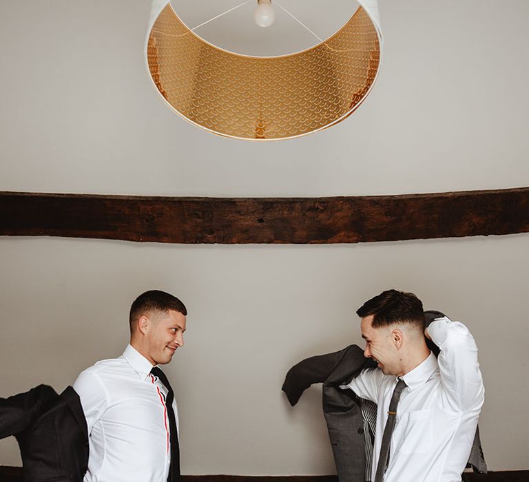 Grooms getting their suits on for wedding day