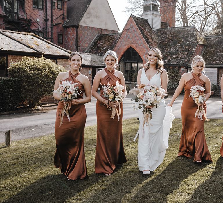 Bridesmaids in elegant halter neck copper bridesmaid dresses with bride in Made With Love Bridal gown