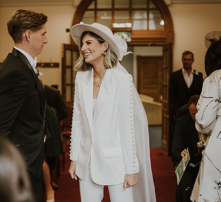 Bride and groom smile during wedding ceremony at town hall 