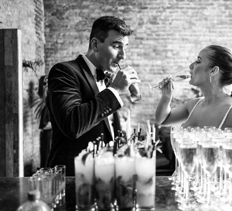 Bride & groom sip drinks at the bar at the 100 Barrington for wedding reception 