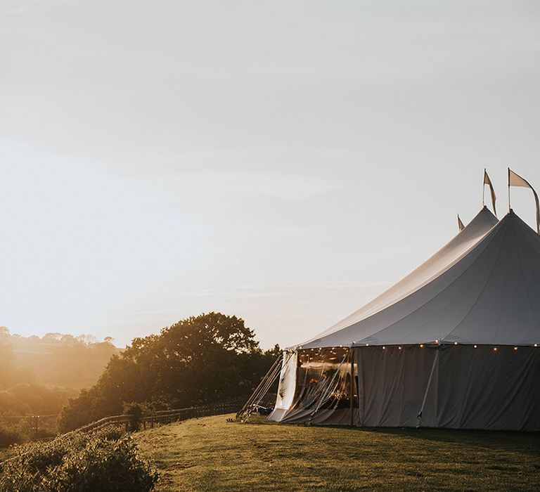 Wedding marquee overlooking stunning views as the sun sets 