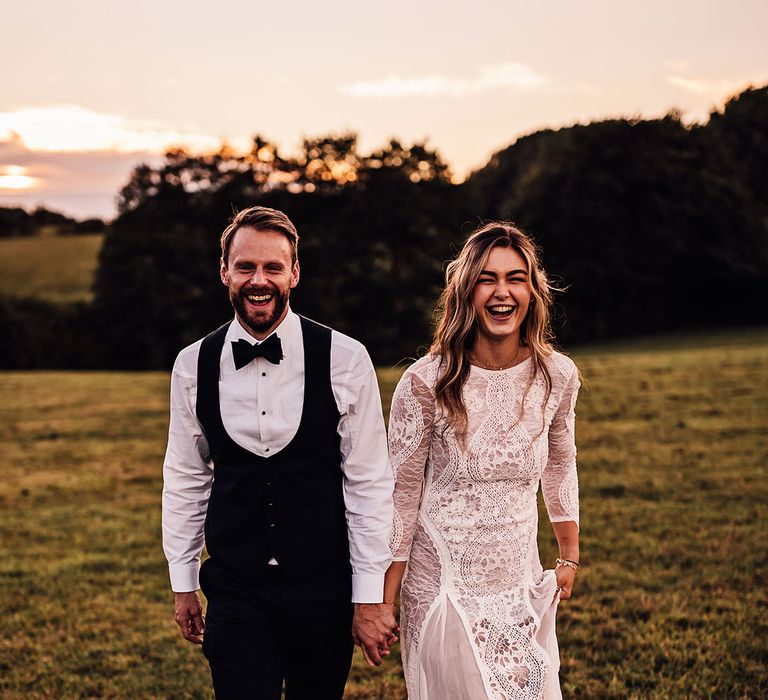 Bride and groom walk holding hands for their wedding at Callow Hall