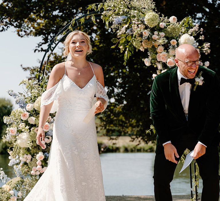 Bride & groom laugh during wedding ceremony outdoors at the Bisham Abbey