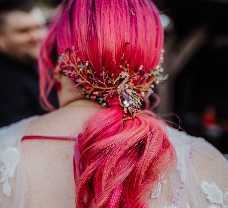 Bride's bright pink hair with peacock design hair clip in pink, blue, silver, gold and green with pink velvet ribbon