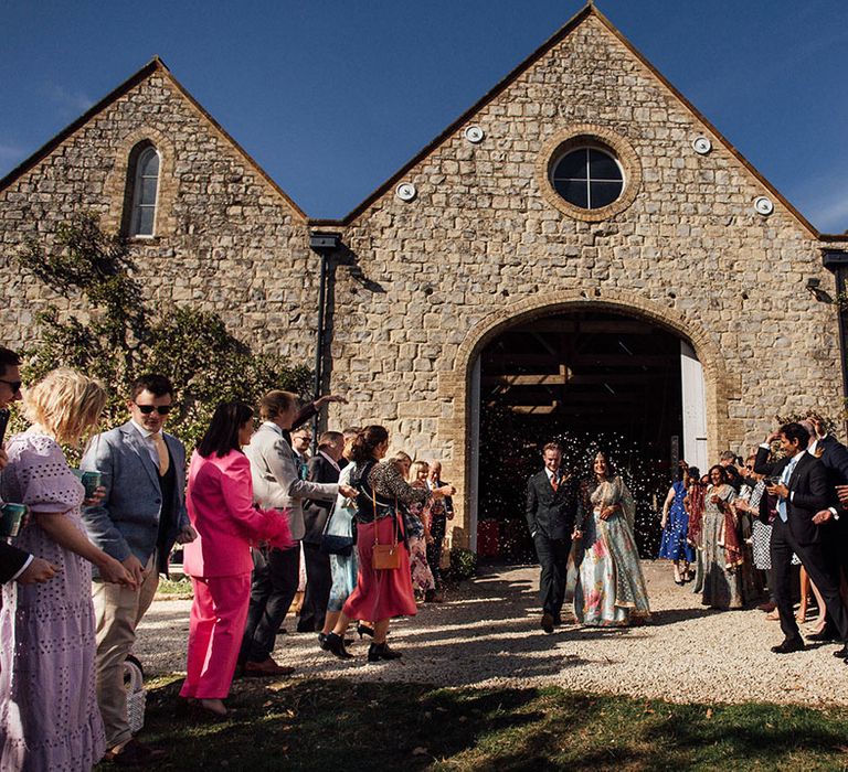 Bride & groom leave Longbourn Estate Barn during confetti exit 