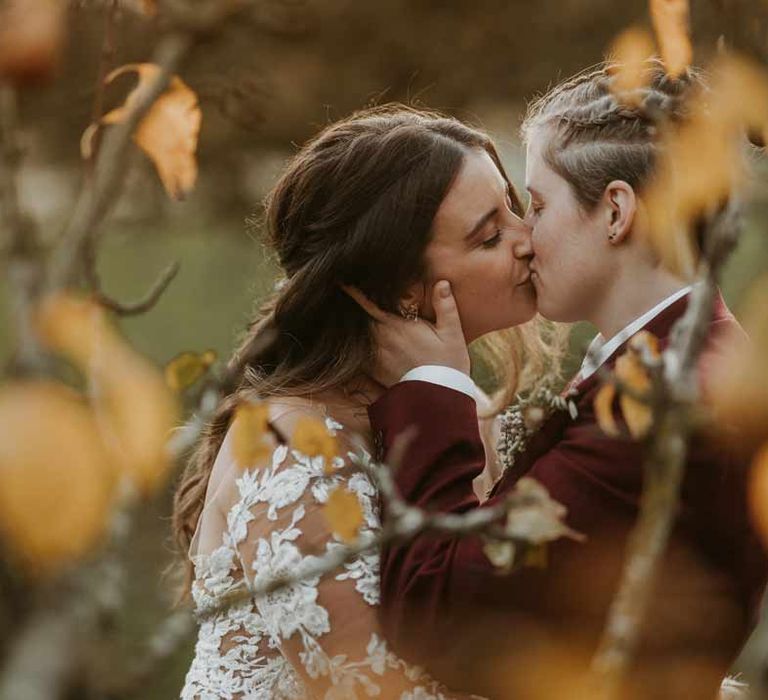 Brides at LGBTQ+ boho wedding doing couples portraits at Bassmead Manor Barns wedding venue Cambridgeshire 