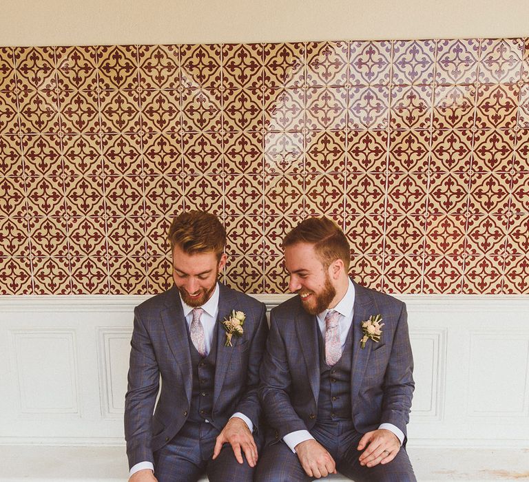 Groom and best man in dark blue wedding suits for the classic style wedding 