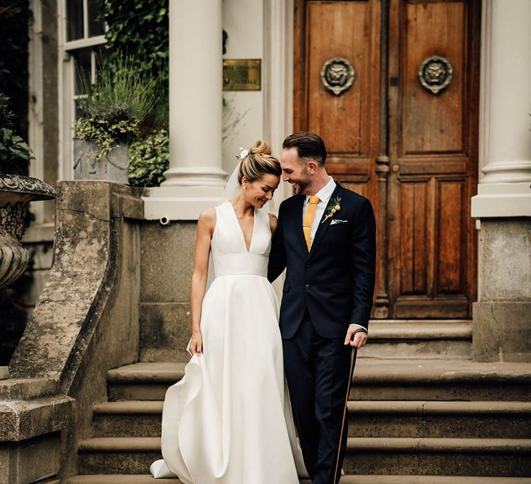 Bride and groom with their pet sausage dog at their Surrey wedding 