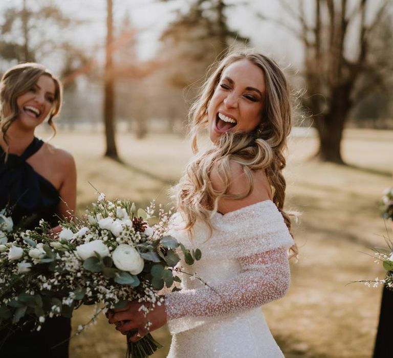 Bride in off shoulder sparkly mermaid wedding dress smiling and laughing into the camera at French destination ski wedding