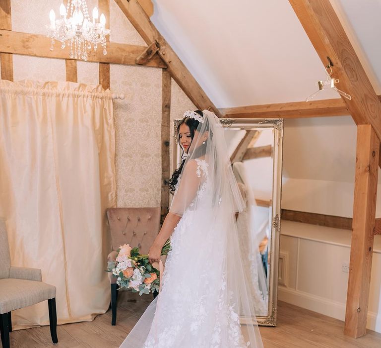 Bride in Savin London wedding dress and an embroidered edge veil 