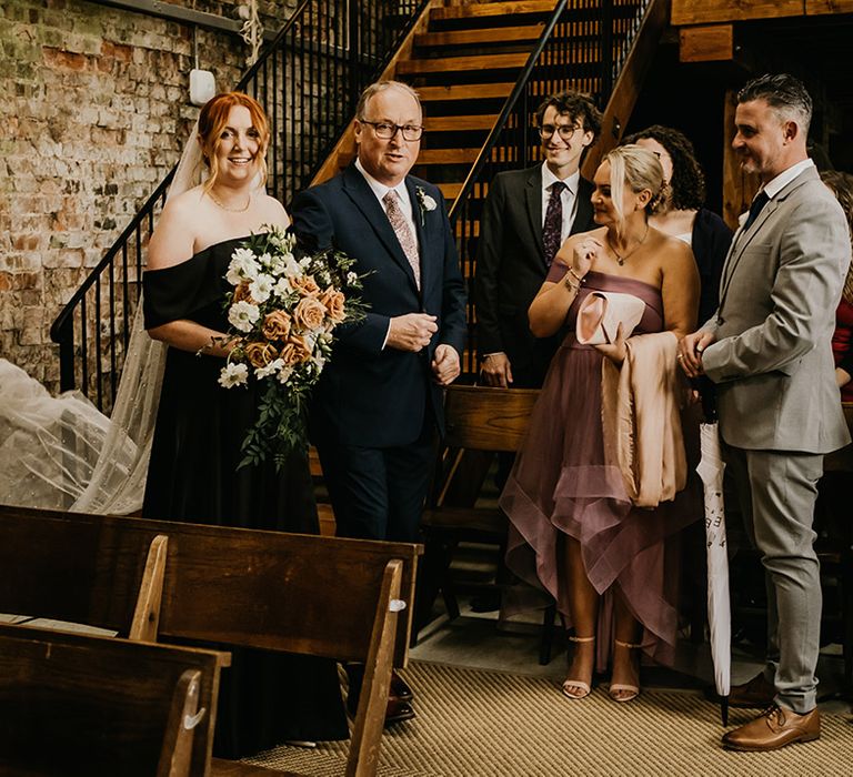 Botley Hill Barn in Surrey wedding with rustic styling with the father of the bride walking down the aisle with the bride 