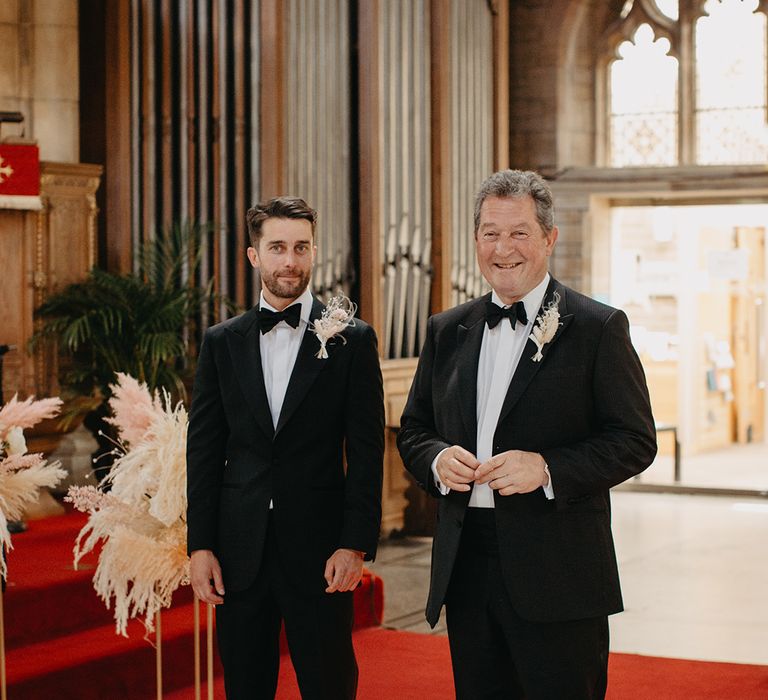 Father of the groom stands by the groom's side for the wedding ceremony 