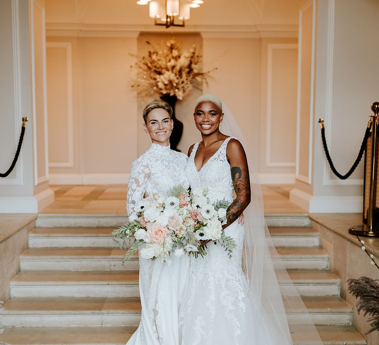 Classic and timeless country house wedding in Wales with two brides wearing lace wedding dresses 