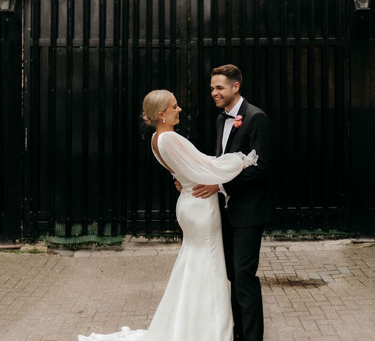 Couple portrait of the bride and groom at their black tie city wedding 