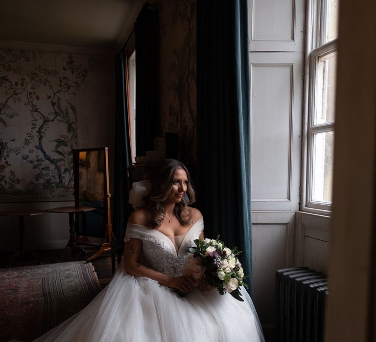 Bride in off the shoulder princess wedding dress at luxe country house wedding 