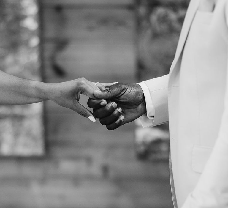 The bride and groom hold hands for their wedding ceremony 