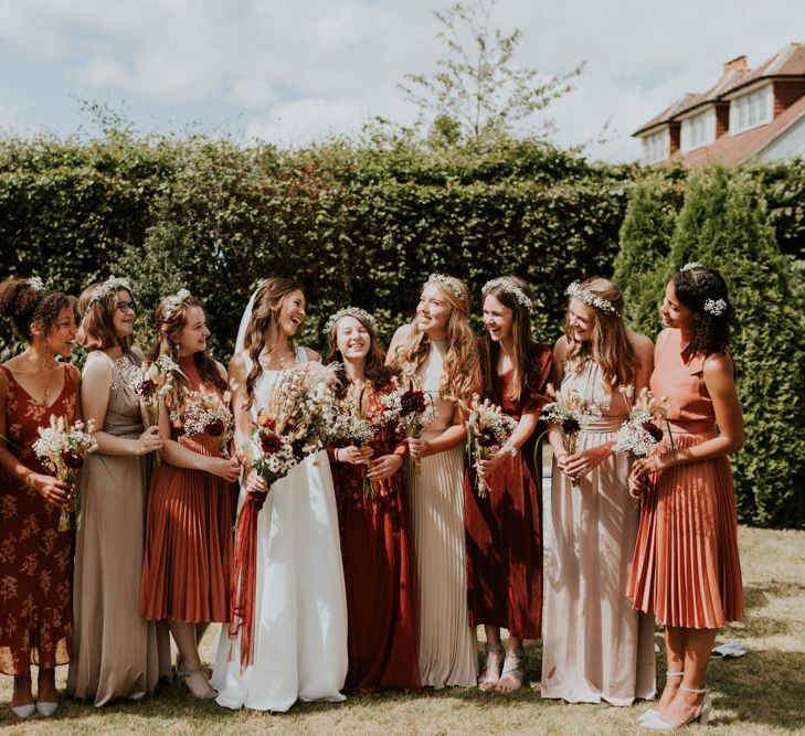 Bridesmaids in orange dresses from the high street 