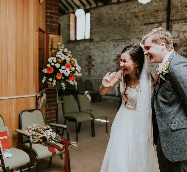 Bride and groom talking to wedding guests virtually at socially distanced wedding 