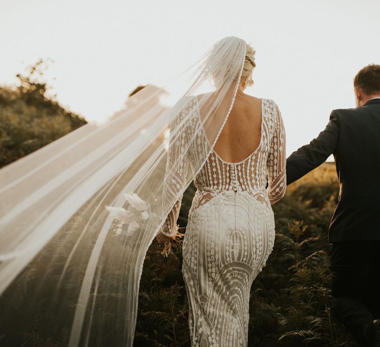 Bride in secondhand wedding dress with intricate design 