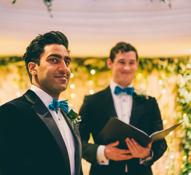 Groom in Tuxedo and teal bow tie for Christmas wedding 