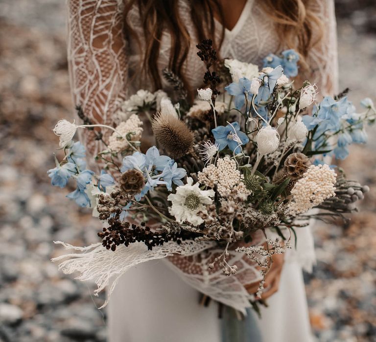 Blue and white wedding bouquet with natural grasses and dried flowers 