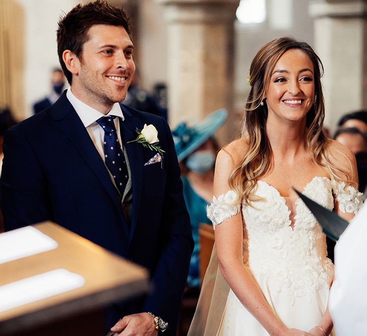 Church wedding with the bride wearing a cold shoulder wedding dress