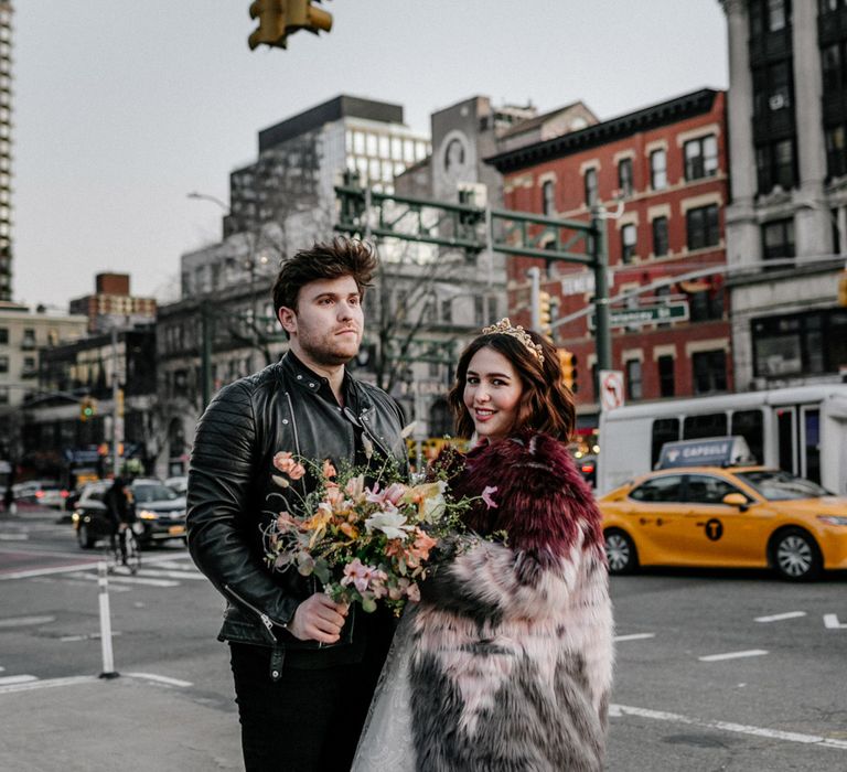 Groom carries floral bouquet in New York elopement 