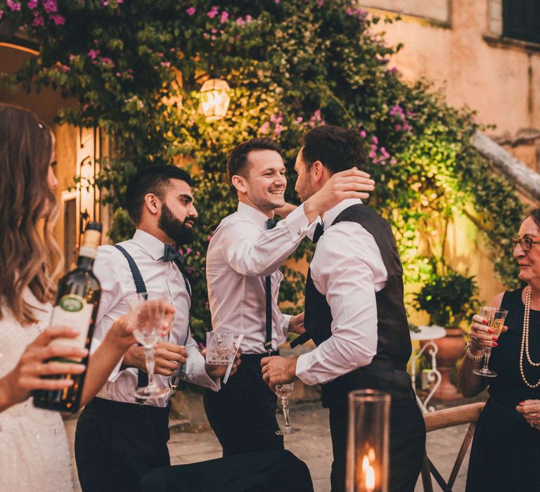 Wedding guests celebrating with Champagne for Italy outdoor wedding