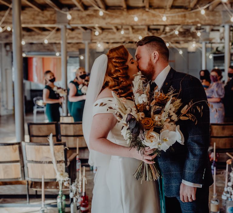 Bride and groom kissing at Holmes Mill, Clitheroe micro wedding