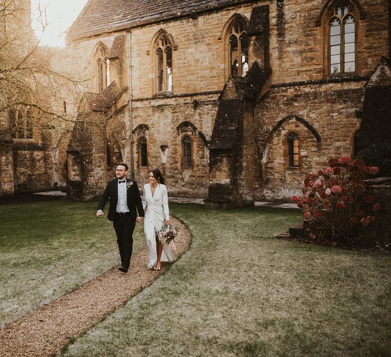 Bride & groom walk through Sherborne School grounds 