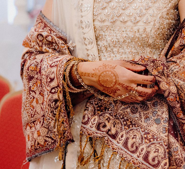 Bride wearing maroon coloured shawl on wedding day 