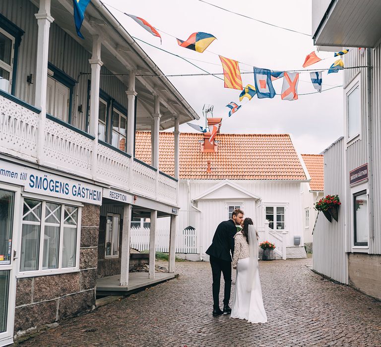 The bride and groom walking through the streets of Smogen, Sweden