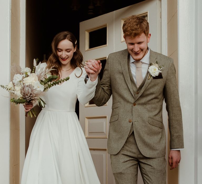 The bride and groom exiting the chapel