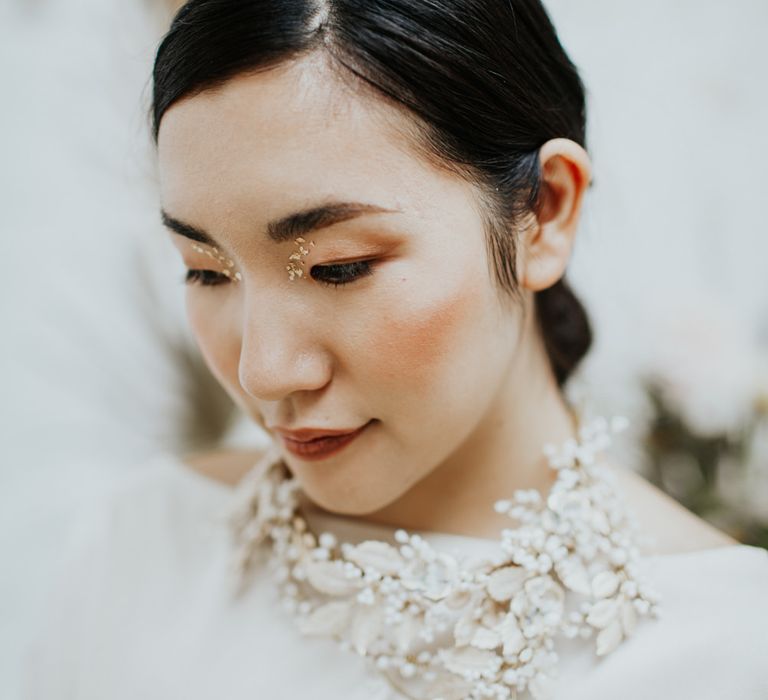 The bride's hair accessory doubles as a statement necklace for use after the wedding day