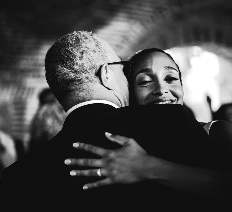 The bride hugging her guests and smiling