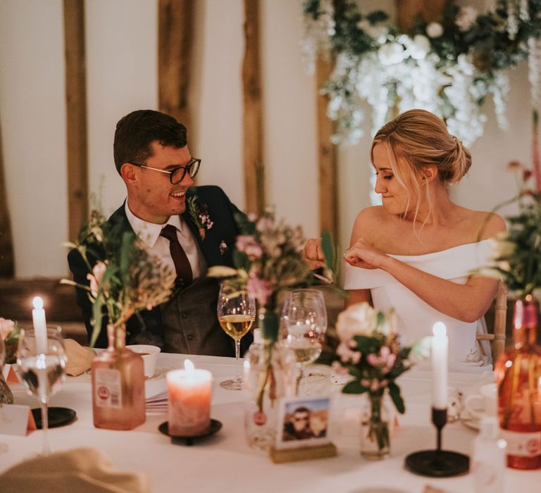 Bride & groom fist bump during wedding reception