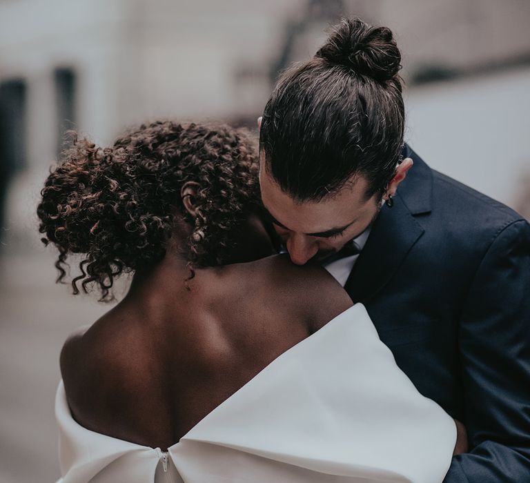 Bride & groom embrace outdoors