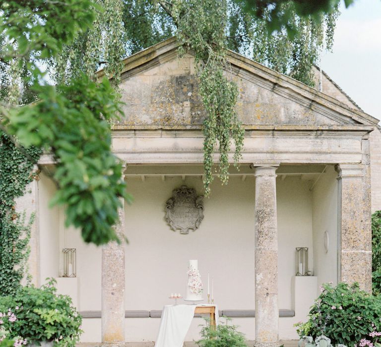 Four tier white wedding cake at Barnsley house for English garden party wedding