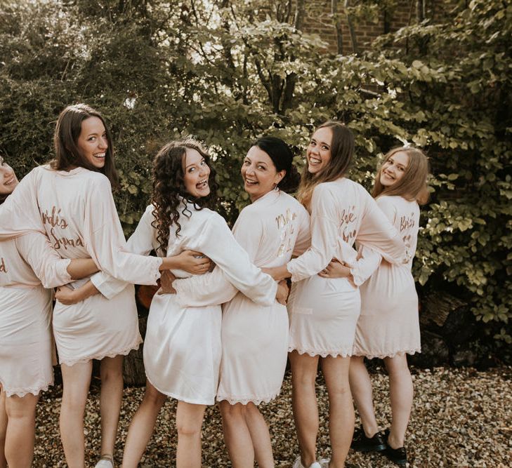 Bridal party in matching 'Bride's Squad' getting ready robes 