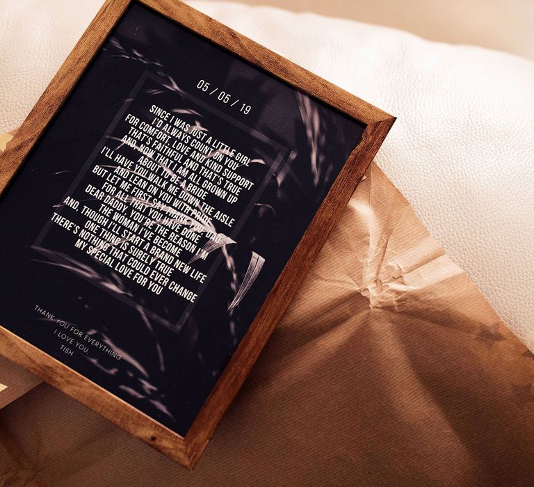 Dark wooden framed sign with poem written in white text and black background for her father