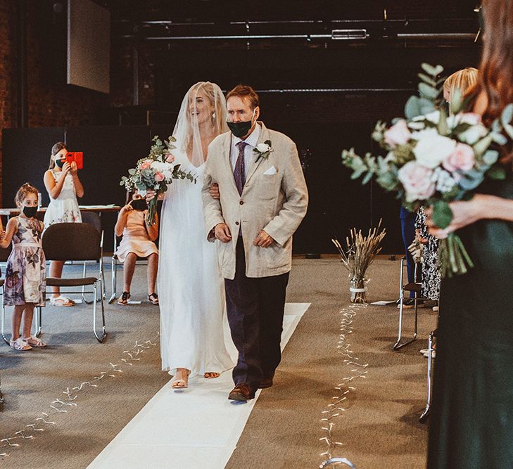 Church wedding ceremony bridal entrance in a slip wedding dress and cathedral length veil